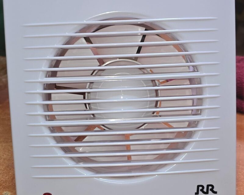 Wall mounted exhaust ventilation fan with front grille